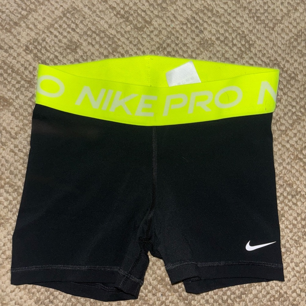 small blake nike pros with neon yellows waist band